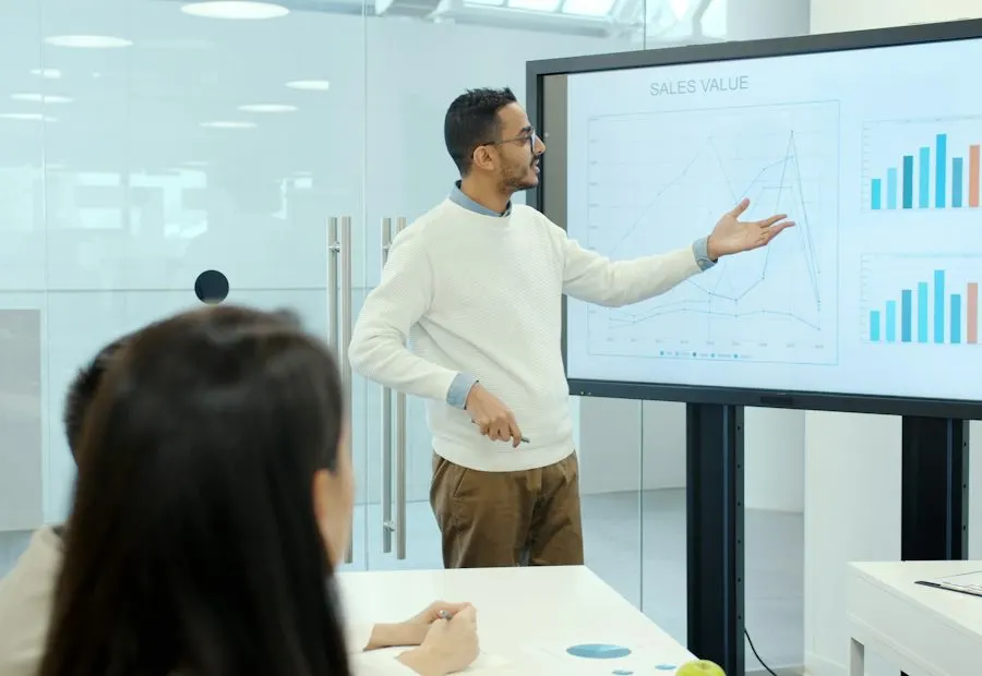 Consultant presenting charts on a screen to a client